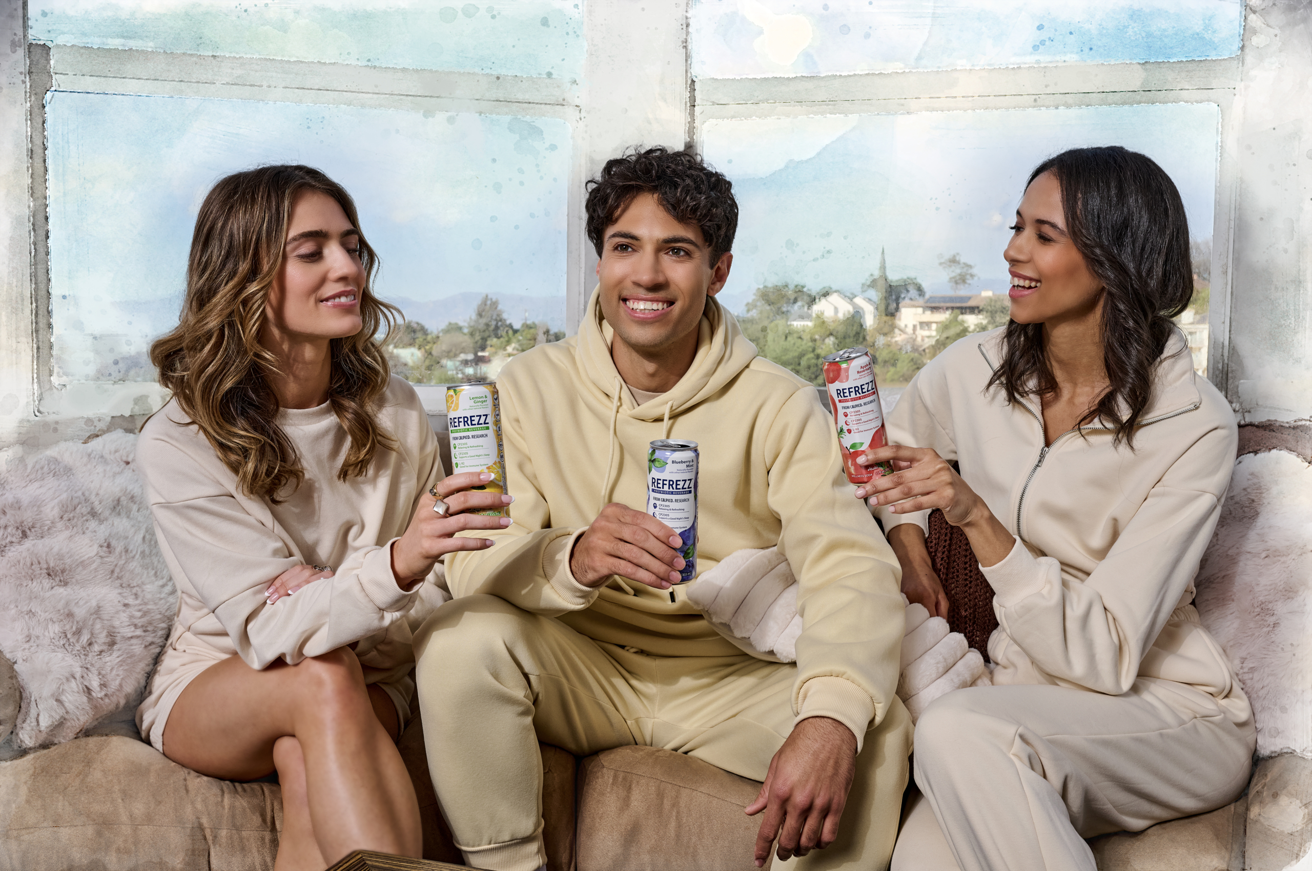 Three cheerful friends in casual wear posing with Refrezz canned beverages.